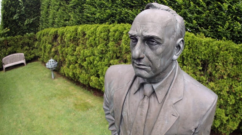 A statue of Robert Moses, who shaped New York's highways,...