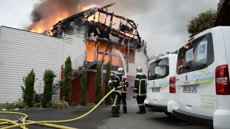 Firefighters try to contain the blaze at a vacation home...