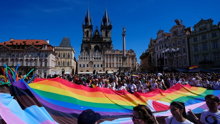 People march during the LGBTQ+ parade at the Old Town...
