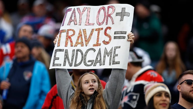 A fan displays a sign that calls attention to Taylor...