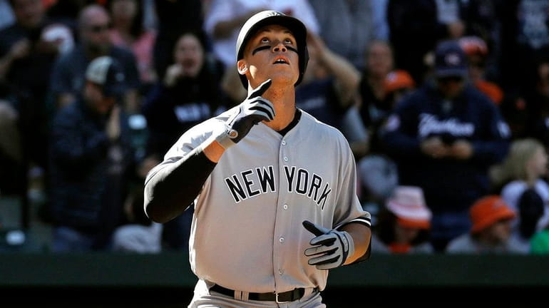 New York Yankees' Aaron Judge gestures as he crosses home...