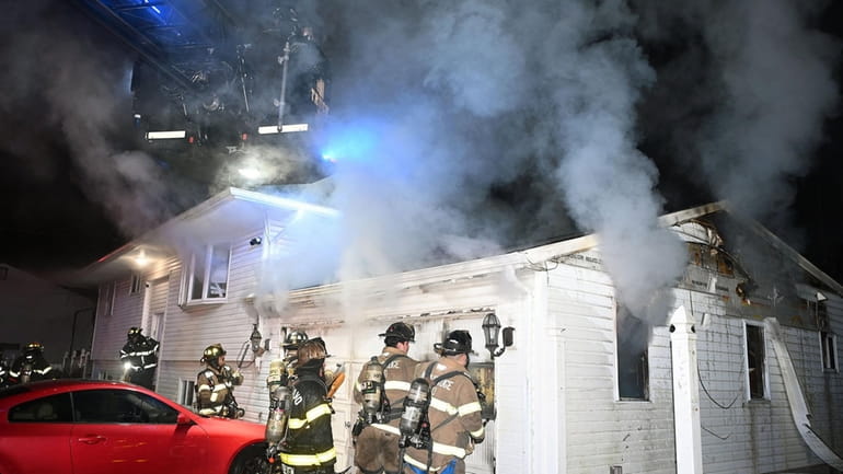 The Central Islip Fire Department battles a Christmas Eve fire at...