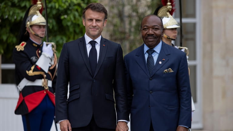 French President Emmanuel Macron, left, welcomes President of Gabon Ali...