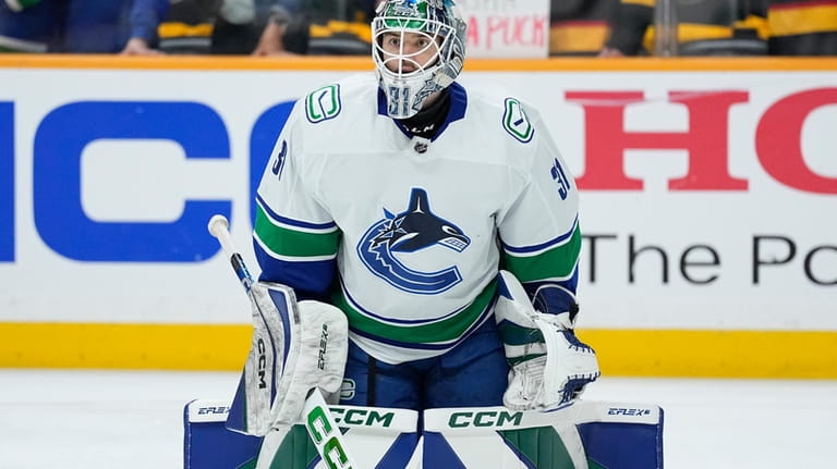 Vancouver Canucks goaltender Arturs Silovs (31) warms up before the...
