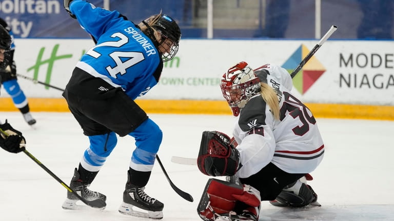 Ottawa goalie Emerance Maschmeyer, right, stops Toronto's Natalie Spooner (24)...