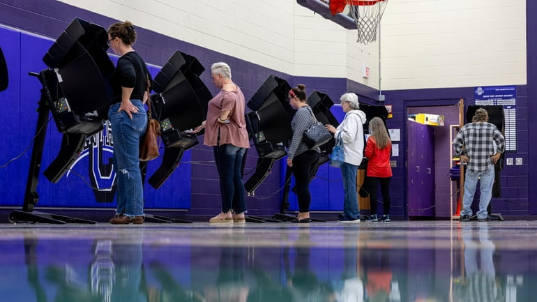 Voters fill out ballots on Election Day at Chesapeake Elementary...
