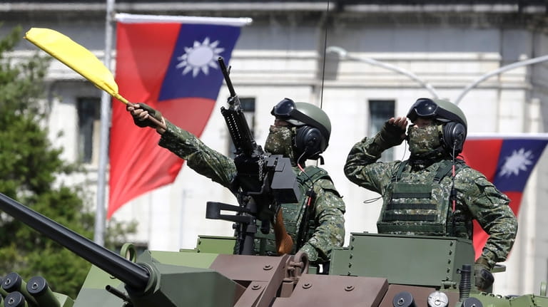 Taiwanese soldiers salute during National Day celebrations in front of...