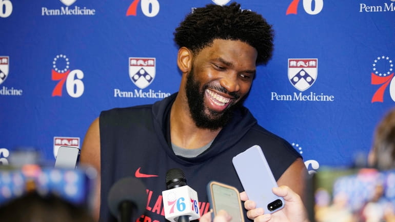 76ers center Joel Embiid jokes with reporters during media availability on Oct....