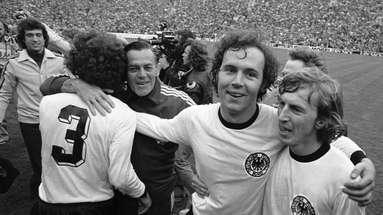 West German national soccer team captain Franz Beckenbauer, second from...