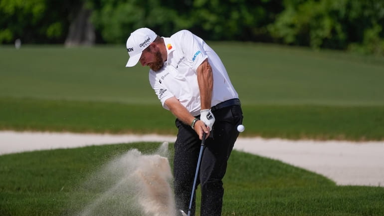Shane Lowry, of Ireland, hits out of the sand on...