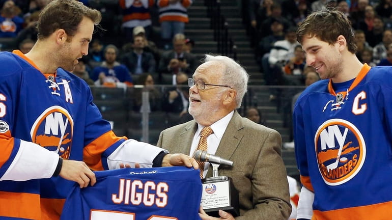 Long time hockey broadcaster Jiggs McDonald is presented gifts from...