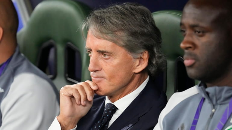 Saudi Arabia's head coach Roberto Mancini sits in his team...