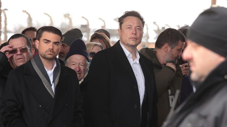 Tesla and SpaceX's CEO Elon Musk, centre, walks during his...