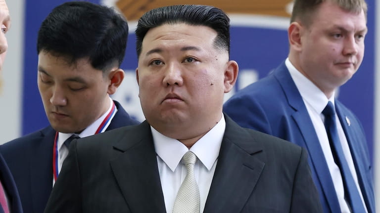 North Korea's leader Kim Jong Un, center, examines a rocket...