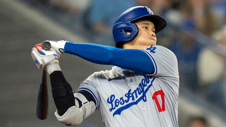 Los Angeles Dodgers designated hitter Shohei Ohtani hits a line...