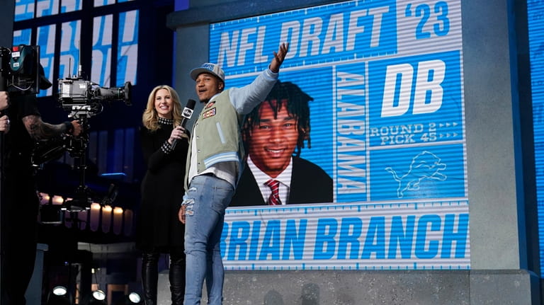 Alabama defensive back Brian Branch, right, reacts after being chosen...