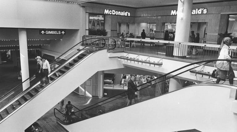 Customers ride the new escalators at Green Acres in 1983.