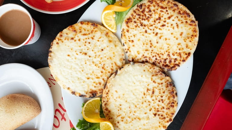 A trio of cheese covered arepas are served at Punto Rojo...