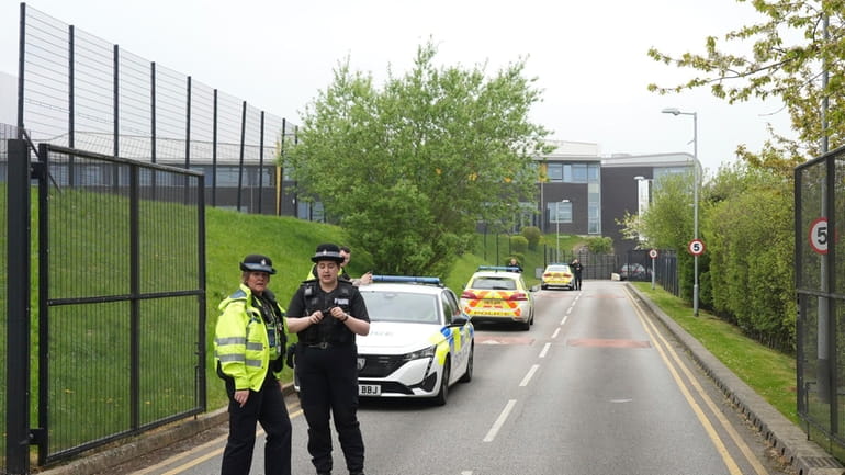 Police stand outside the Birley Academy in Sheffield, northern England,...