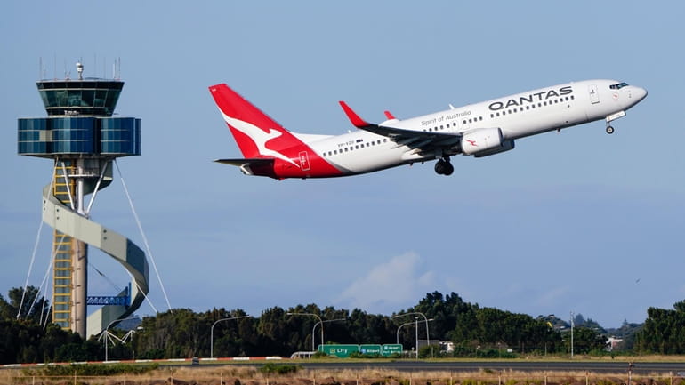 A Qantas Boeing 737 passenger plane takes off from Sydney...