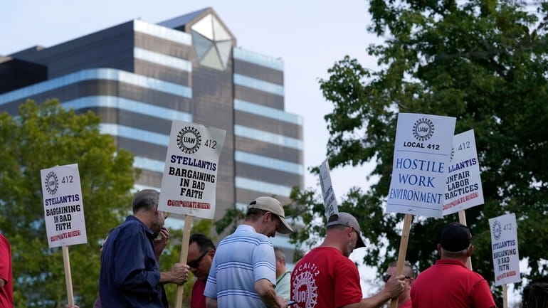 United Auto Workers march outside the Stellantis North American Headquarters,...