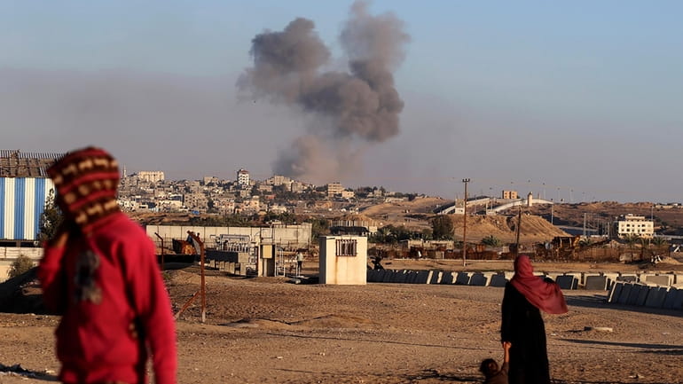 Smoke rises following an Israeli airstrike on buildings near the...