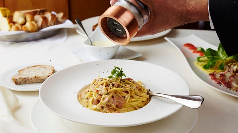 Spaghetti alla carbonara, a classic Roman dish, is expertly prepared...