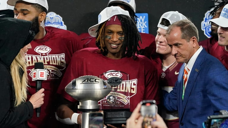 Florida State running back Lawrance Toafili, center, receives the most...