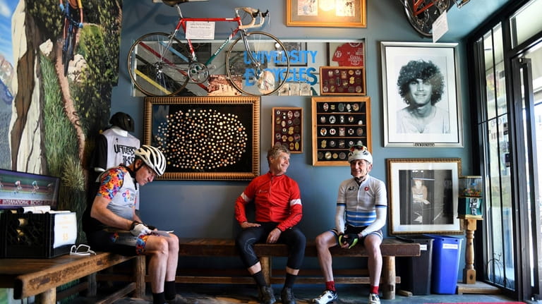 University Bicycles owner Douglas Emerson, center, talks with friends in...