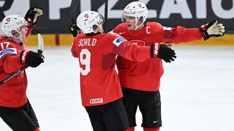 Switzerland's Jonas Taibel, right, celebrates scoring during the IIHF World...