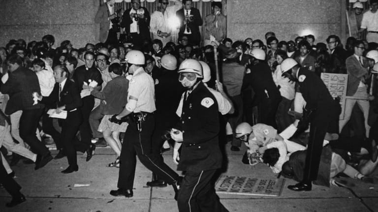 Chicago Police attempt to disperse demonstrators outside the Conrad Hilton,...