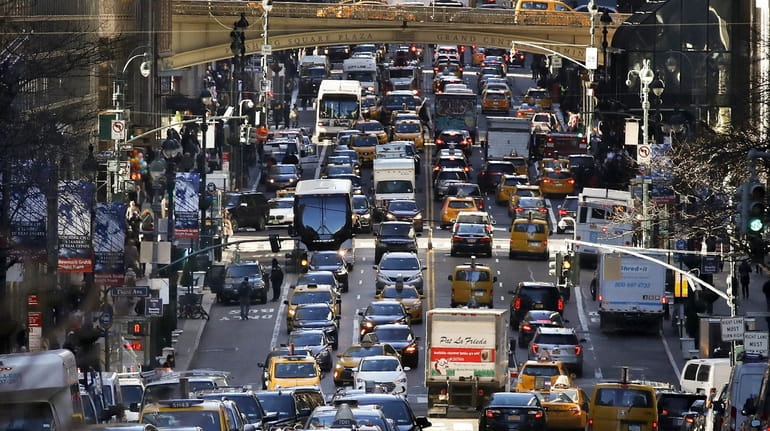 Traffic moves along 42nd Street in Midtown Manhattan, Jan. 25,...