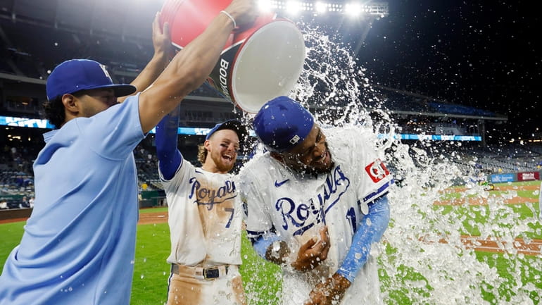 Kansas City Royals' Maikel Garcia, right, is doused by MJ...