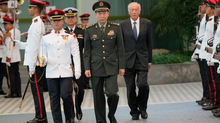 Chinese Defense Minister Gen. Li Shangfu, center, inspects the honor...