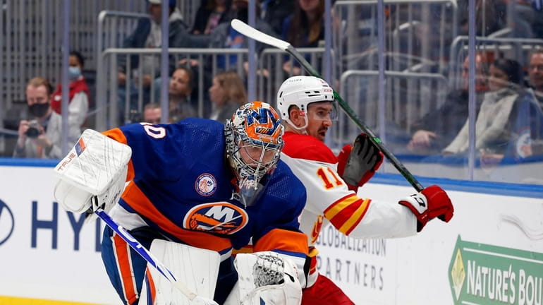 Semyon Varlamov #40 of the Islanders battles behind the net during...