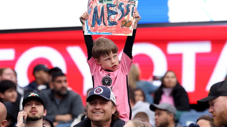 A young fan shows his support for Inter Miami forward...