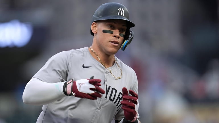 Yankees' Aaron Judge runs the bases after hitting a solo...
