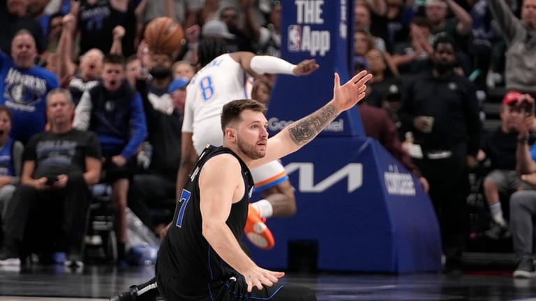 Dallas Mavericks' Luka Doncic looks to an official after sinking...