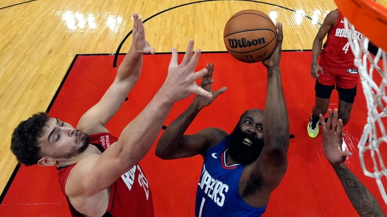 Los Angeles Clippers' James Harden(1) goes up for a shot...