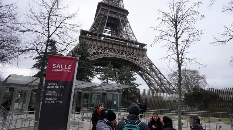 Tour Eiffel employees talks to visitors at the Eiffel Tower,...