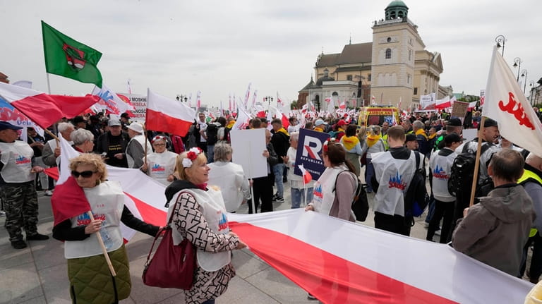 Polish farmers and other protesters gather in downtown Warsaw to...