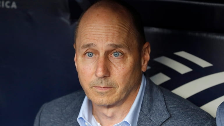 Yankees general manager Brian Cashman looks on before a game...