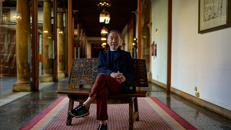 Japanese author Haruki Murakami poses ahead of an interview with...