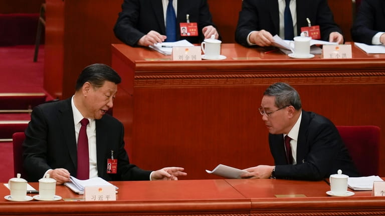 Chinese President Xi Jinping, left, talks with Chinese Premier Li...