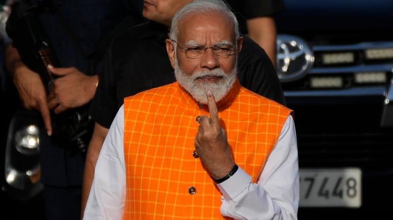 Indian Prime Minister Narendra Modi, shows the indelible ink mark...