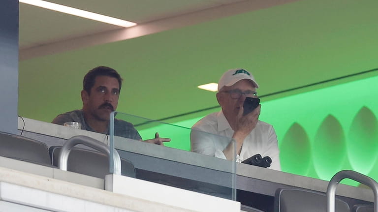 Aaron Rodgers #8 of the New York Jets watches a...
