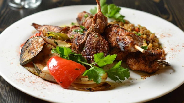 The Mixed Grill entree includes lamb chop, grilled skewered pork...
