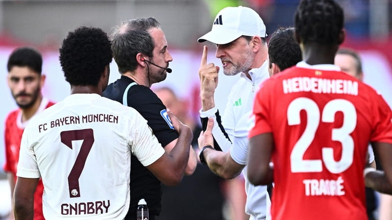 Munich head coach Thomas Tuchel, center right, complains to referee...