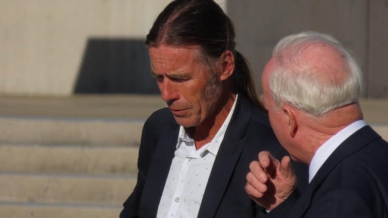 Montauk fisherman Christopher Winkler confers with his lawyer, Peter Smith...