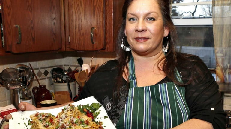 Lisa Cocchi of Brentwood holds a dish tagliatelle carbonara with...